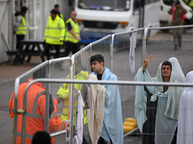 Detainees are seen wrapped in blankets inside the Manston short-term holding centre for mi