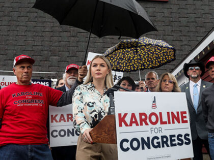 Londonderry, NH: Attendees hold umbrellas to block light rain as Karoline Leavitt, a Republican candidate for the U.S. House, speaks at a press conference held at Esteys Country Store, Oct.18, 2022. (Cheryl Senter for The Washington Post via Getty Images)