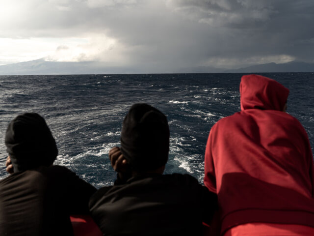 AT SEA - NOVEMBER 05: Rescued irregular migrants are seen on deck after a night under bad