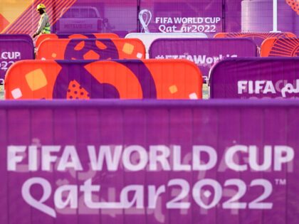 A worker walks past FIFA World Cup banners outside the Khalifa Stadium in Doha on November 6, 2022, ahead of the Qatar 2022 FIFA World Cup football tournament. (Photo by Kirill KUDRYAVTSEV / AFP) (Photo by KIRILL KUDRYAVTSEV/AFP via Getty Images)