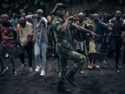 A Congolese soldier leads a session to enroll new recruits into the army to go to the fron