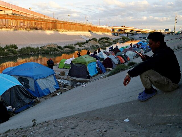 Migrants camp on the banks of the Rio Bravo river (or Rio Grande river, as it is called in the US) in Ciudad Juarez, Chihuahua state, Mexico, on November 15, 2022. - A US federal judge ruled on November 15 that the government could not use public health rules to …