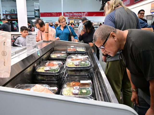 People shop for food items, including portioned turkey dinners, at a Costco store in Monterey Park, California on November 22, 2022. - Inflation in the United States has soared to the highest levels in recent decades, leading the Federal Reserve to embark on an aggressive campaign to cool the world's …