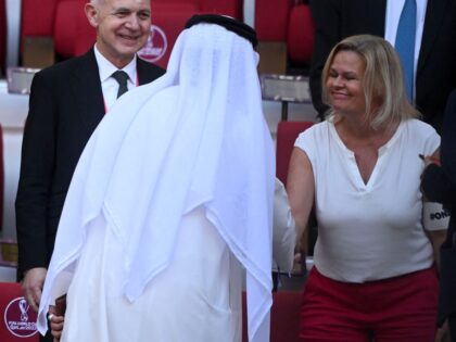 German Interior Minister Nancy Faeser (R) wearing an One Love armband shakes hands with an official next to the president of the German Football Association (DFB) (2L), Bernd Neuendorf, and FIFA President Gianni Infantino (L) before the Qatar 2022 World Cup Group E football match between Germany and Japan at …