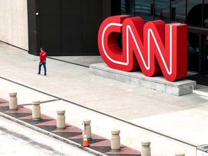 People walk by the world headquarters for CNN on March 15, 2022 in Atlanta, Georgia. Last