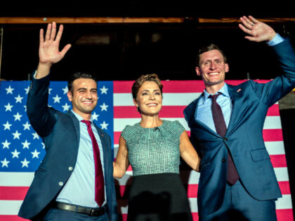 PHOENIX, ARIZONA - AUGUST 01: (L-R) Republican candidate for state attorney general Abraham Hamadeh, Republican gubernatorial candidate Kari Lake, and Republican U.S. senatorial candidate Blake Masters wave to supporters at the conclusion of a campaign event on the eve of the primary at the Duce bar on August 01, 2022 …