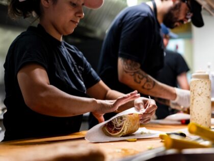 WASHINGTON, DC - AUGUST 19: Cooks prepare sandwiches on a counter at Bub and Pop's on August 19, 2022 in Washington, DC. Since the beginning of Covid-19 restaurant owners have had to weather a rise in costs of supplies on top of employee turnover. According to Bub and Pop’s part …