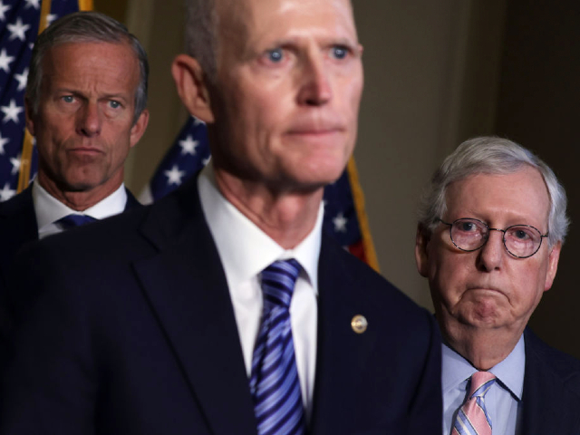 WASHINGTON, DC - SEPTEMBER 13: U.S. Sen. Rick Scott (R-FL) (C) speaks to members of the press as Senate Minority Leader Sen. Mitch McConnell (R-KY) (R) and Senate Minority Whip Sen. John Thune (R-SD) (L) listen after a weekly Republican policy luncheon at the U.S. Capitol September 13, 2022 in Washington, DC. Senate GOPs held a weekly policy luncheon to discuss the Republican agenda. (Photo by Alex Wong/Getty Images)