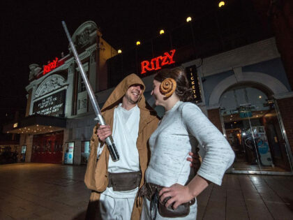 LONDON, ENGLAND - DECEMBER 16: Couple Rob Blakemore, 39 and Verity Owers, 37, get dressed up as a Jedi Knight and Princess Leia, including cinnamon rolls for Leia's hair, before the first public screening of Star Wars: The Force Awakens at midnight at Ritzy Picturehouse on December 16, 2015 in …