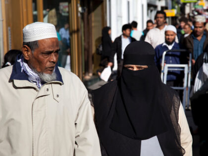 People from various ethnic backgrounds around the market on Whitechapel High Street in East London. This area in the Tower Hamlets is predominantly Muslim with just over 50% from Bangladeshi descent. This is known as a very poor area of London's East End. (Photo by In Pictures Ltd./Corbis via Getty …