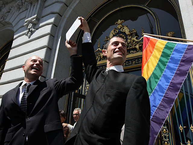 Same-sex couple Paul Festa (R) and James Harker hold their marriage license after they wer