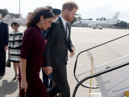 Britain's Prince Harry and his wife Meghan, the Duchess of Sussex board a plane for N
