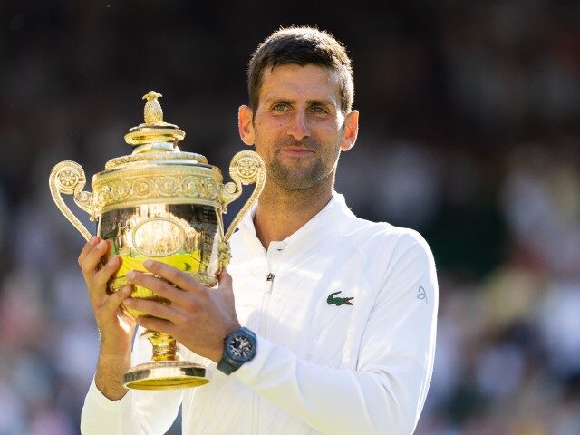 Novak Djokovic of Serbia with the trophy after victory in the Men’s Singles Final agains