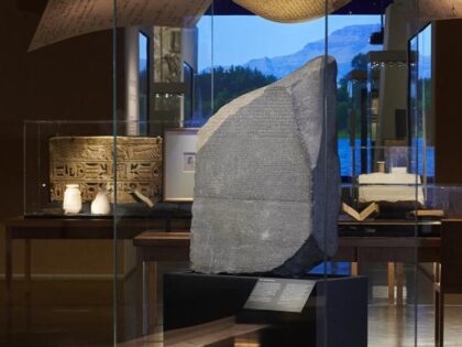 This undated photo provided by the British Museum, shows the Rosetta Stone, the centerpiece of a new exhibition at London’s largest museum titled, "Hieroglyphs unlocking ancient Egypt," celebrating the 200th anniversary of the stone's decipherment, at the British Museum, in London. Thousands of Egyptians are demanding that the British Museum …