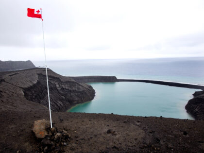 The national flag of Tonga flies over the newest island on Earth, July 10, 2015. The government of Tonga issued a tsunami warning on Friday after an earthquake of magnitude 7.3 struck in the sea around 207 kilometres from the capital. Edwina Pickles/The Sydney Morning Herald/Fairfax Media via Getty Images