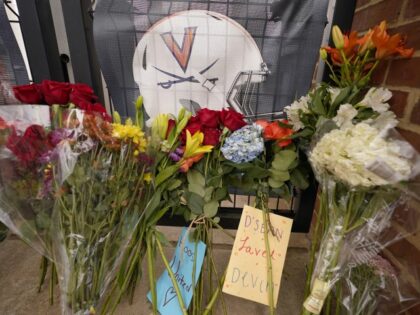 Memorial flowers and notes line walkway at Scott Stadium after three football players were killed in a shooting on the grounds of the University of Virginia Tuesday Nov. 15, 2022, in Charlottesville. Va. Authorities say three people have been killed and two others were wounded in a shooting at the …
