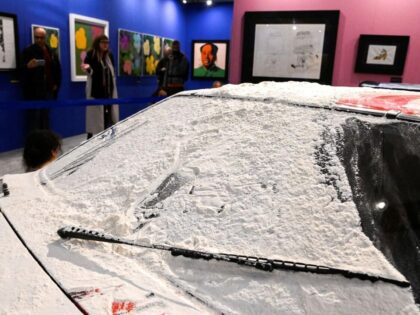 Climate activists threw flour over a car repainted by American artist Andy Warhol in Milan on Friday, part of a wave of environmental protests demanding action on climate change.