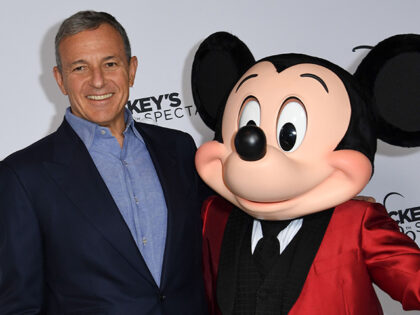 Walt Disney Company Chairman and CEO Bob Iger poses with Mickey Mouse at The Shrine Auditorium on October 6, 2018, in Los Angeles. (Valerie Macon/AFP via Getty Images)