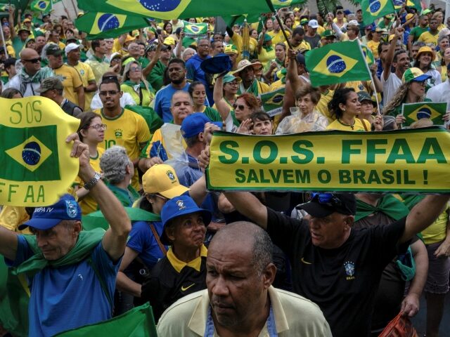 Supporters of Brazilian President Jair Bolsonaro hold signs asking for military interventi