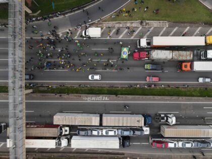 Aerial view showing supporters of President Jair Bolsonaro, mainly truck drivers, blocking Castelo Branco Highway, on the outskirts of Sao Paulo, Brazil, on November 1, 2022. - Supporters of Brazilian President Jair Bolsonaro blocked major highways for a second day as tensions mounted over his silence after narrowly losing re-election …