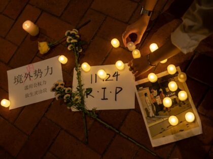 HONG KONG, CHINA - NOVEMBER 29: A protester places a candle on the ground during a vigil c