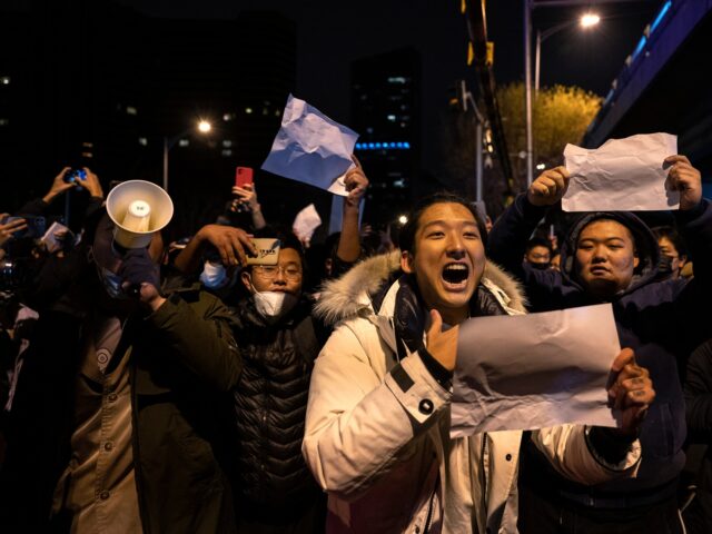 BEIJING, CHINA - NOVEMBER 28: A protester shouts slogans against China's strict zero COVID measures on November 28, 2022 in Beijing, China. Protesters took to the streets in multiple Chinese cities after a deadly apartment fire in Xinjiang province sparked a national outcry as many blamed COVID restrictions for the …