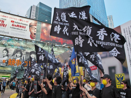 Protesters hold banners during a rally against Communist China's government in Tokyo, Japan on July 2. Hong Kong officials complained on Sunday that South Korean rugby officials played a protest song connected to anti-government demonstrations in 2019 in place of the Chinese national anthem before a match. File Photo by …