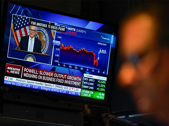 Traders work on the floor at the New York Stock Exchange as the Federal Reserve chairman J