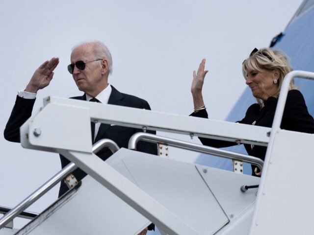 US First Lady Jill Biden and US President Joe Biden gesture while boarding Air Force One at London Stansted Airport in Stansted, United Kingdom, on September 19, 2022. - The Bidens are returning from the United Kingdom, after attending the state funeral of Queen Elizabeth II. (Photo by Brendan Smialowski …