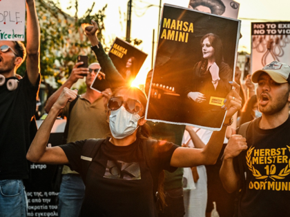 A protester holds a portrait of Iranian Mahsa Amini during a demonstration by Iranians liv