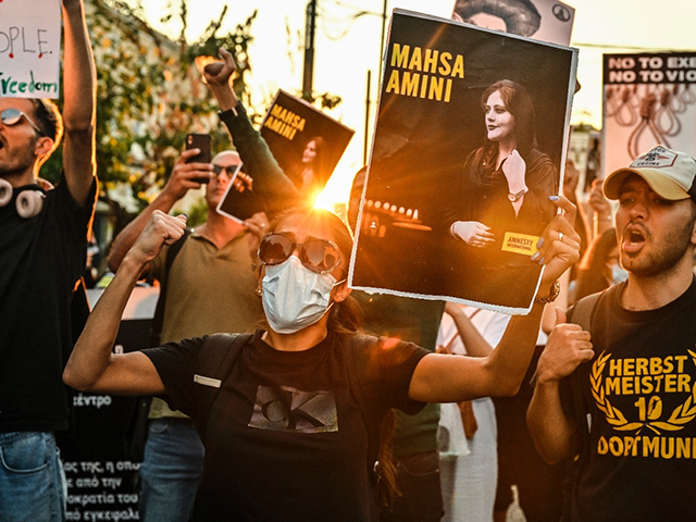 A protester holds a portrait of Iranian Mahsa Amini during a demonstration by Iranians living in Greece in central Athens on September 24, 2022, following the death of an Iranian woman after her arrest by the country's morality police in Tehran. - Mahsa Amini, 22, was on a visit with her family to the Iranian capital Tehran, when she was detained on September 13, 2022, by the police unit responsible for enforcing Iran's strict dress code for women, including the wearing of the headscarf in public. (Photo by Louisa GOULIAMAKI / AFP) (Photo by LOUISA GOULIAMAKI/AFP)
