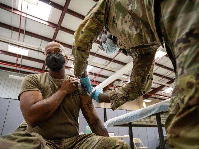 FORT KNOX, KY - SEPTEMBER 09: Preventative Medicine Services NCOIC Sergeant First Class Demetrius Roberson administers a COVID-19 vaccine to a soldier on September 9, 2021 in Fort Knox, Kentucky. The Pentagon, with the support of military leaders and U.S. President Joe Biden, mandated COVID-19 vaccination for all military service …