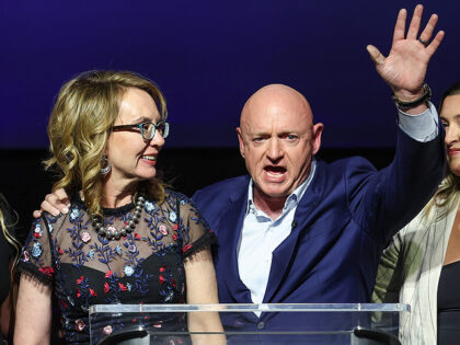 TUCSON, ARIZONA - NOVEMBER 08: U.S. Sen. Mark Kelly (D-AZ) and his wife former Congresswoman Gabby Giffords, daughters Charlotte and Samantha wave during his election night rally at the Rialto Theatre on November 08, 2022 in Tucson, Arizona. Senator Mark Kelly is running for reelection against his Republican opponent Blake …