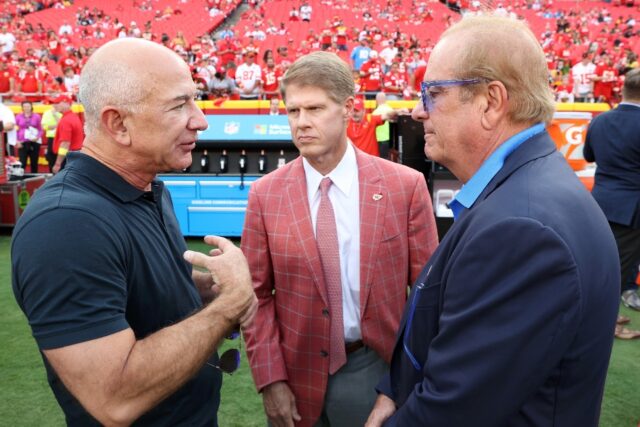 Amazon founder Jeff Bezos -- at left talking with NFL team owners Clark Hunt, center, of t