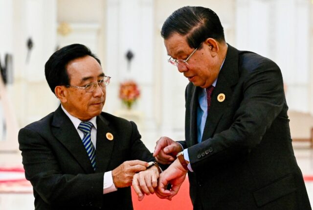 Cambodia's Prime Minister Hun Sen (R) is gifting leaders like Laos' Prime Minister Phankha