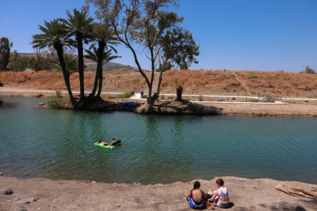 Israelis camping by the Jordan River near the Sea of Galilee, or Lake Tiberias, one of the