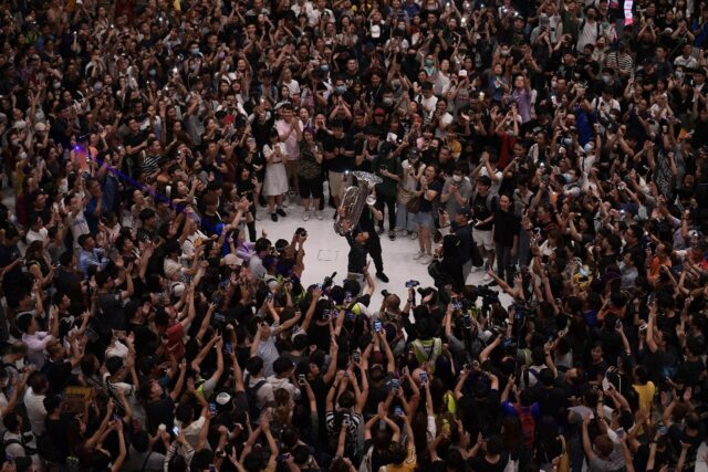 People gather at a shopping mall in September 2019 to sing 'Glory to Hong Kong', which bec