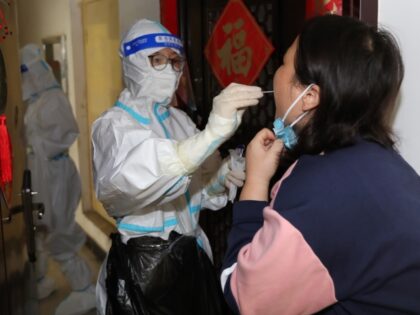 ZHENGZHOU, CHINA - NOVEMBER 01 2022: A medical worker takes swab samples on residents during a door-to-door Covid-19 screening in Zhengzhou in central China's Henan province Tuesday, Nov. 01, 2022. (Photo credit should read / Feature China/Future Publishing via Getty Images)