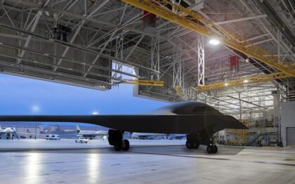 Artist rendering of a B-21 Raider in a hangar is seen with the background being Ellsworth Air Force Base, South Dakota, one of the future bases to host the new airframe. (U.S. Air Force graphic)