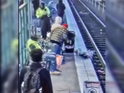 A child being shoved onto train tracks