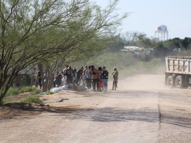 A group of nearly 30 migrants surrender to Texas Army National Guard soldiers near Eagle P