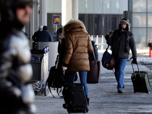 Passengers walk through Terminal 3 at O'Hare International Airport in Chicago, Thursday, J