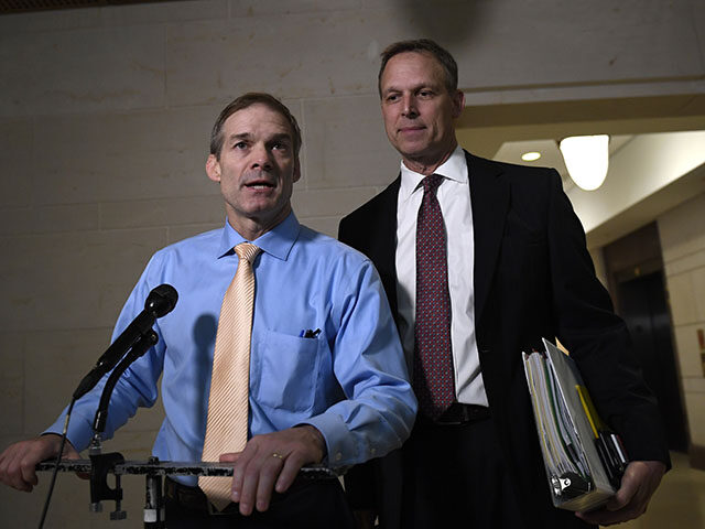 Rep. Jim Jordan, R-Ohio, left, and Rep. Scott Perry, R-Pa., right, speak to reporters on Capitol Hill in Washington, Thursday, Oct. 31, 2019, outside the are where witnesses are interviewed for the impeachment inquiry. (AP Photo/Susan Walsh)