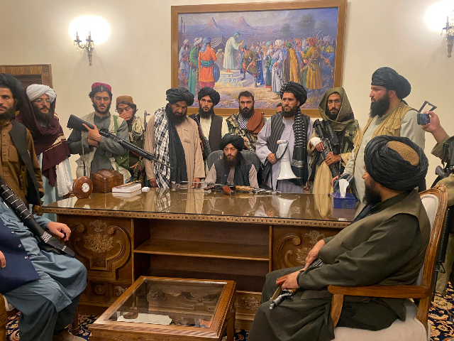 FILE - In this Aug. 15, 2021 file photo, Taliban fighters take control of Afghan presidential palace in Kabul, Afghanistan, after President Ashraf Ghani fled the country. (AP Photo/Zabi Karimi, File)