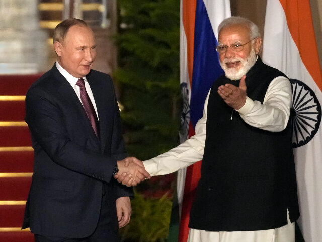 Russian President Vladimir Putin, left and Indian Prime Minister Narendra Modi greet each other before their meeting in New Delhi, India, Monday, Dec.6, 2021. Indian Prime Minister Narendra Modi is meeting Russian President Vladimir Putin on Monday to discuss defense and trade relations as India attempts to balance its ties …