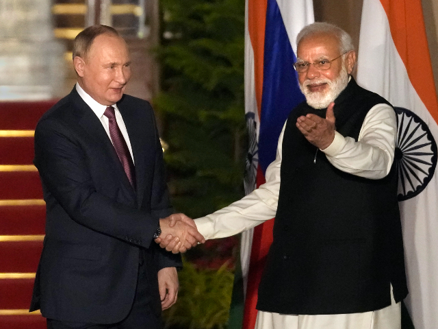 Russian President Vladimir Putin, left and Indian Prime Minister Narendra Modi greet each other before their meeting in New Delhi, India, Monday, Dec.6, 2021. Indian Prime Minister Narendra Modi is meeting Russian President Vladimir Putin on Monday to discuss defense and trade relations as India attempts to balance its ties with the United States. (AP Photo/Manish Swarup)