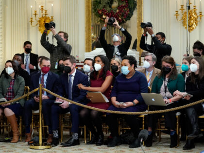 FILE - Members of the White House press corps listen as President Joe Biden speaks about the COVID-19 response and vaccinations Dec. 21, 2021, in the State Dining Room of the White House in Washington. As President Joe Biden wraps up his first year in the White House, he has …