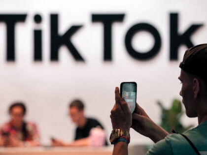 A visitor makes a photo at the TikTok exhibition stands at the Gamescom computer gaming fa
