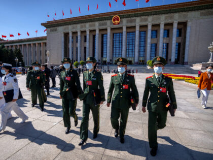 FILE - Military attendees leave after the opening ceremony of the 20th National Congress of China's ruling Communist Party at the Great Hall of the People in Beijing on Oct. 16, 2022. In a speech that used the word security 26 times, Chinese leader Xi Jinping said Beijing will "work …