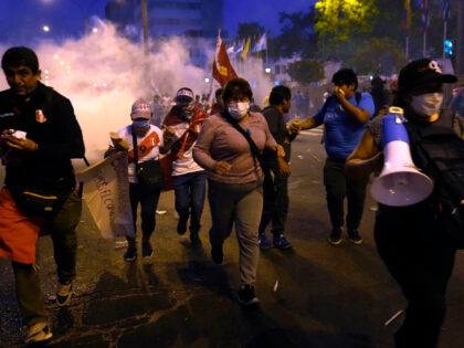 Supporters of ousted President Pedro Castillo run after clashes with riot police in front of Congress in Lima, Peru, Sunday, Dec. 11, 2022. Peru's Congress voted to remove Castillo from office Wednesday and replace him with the vice president, shortly after Castillo tried to dissolve the legislature ahead of a …